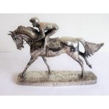A hallmarked silver (filled) late 20th/early 21st century model of a jockey and racehorse in full