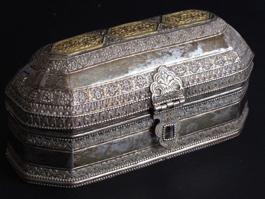 A heavy Eastern white-metal box of octagonal form with straight sides; the top of the hinged lid set