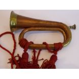 A brass mounted copper bugle; signed 'Barratts, England', together red rope tassels and detachable