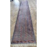 A light-blue ground Pakistan runner with gul pattern (480cm x 79cm)