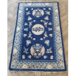 A mid-20th century Chinese blue ground Peking carpet decorated with Fen etc. (245cm x 155cm)The