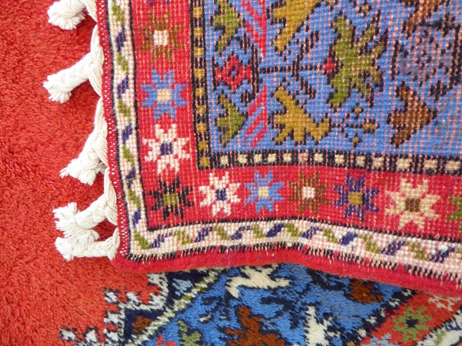 A Moroccan Rabat carpet; central flowerheads against a red ground within blue and red varying - Image 4 of 5