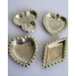 A set of four small hallmarked silver trinket dishes; modelled as playing card suits (clubs,