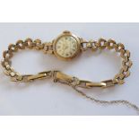 A lady's 9 carat yellow gold wristwatch by Accurist; the circular dial with Arabic numerals and