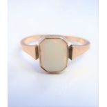 An opal ring, the rectangular cut-cornered opan collet-set to the plain tapering shank stamped '