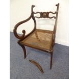 An early 19th century grained (to look like rosewood) open-armed dining chair; the rope-style top-