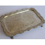 An early 19th century oblong silver tray; raised gadrooned border with shell-style motifs, assay