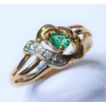 An emerald and diamond-set ring, the pear-shaped emerald claw-set above an openwork setting with