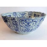 A large 17th century Chinese porcelain bowl: hand-decorated in underglaze blue and white and with