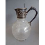 A late 19th century cut, etched and silver-plate-mounted claret jug of ovoid form; the hinged