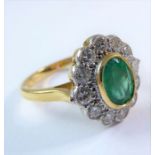 An 18-carat gold Columbian emerald and diamond cluster ring