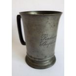 A 19th century pewter quart tankard stamped VR either side of a crown and engraved to the front '
