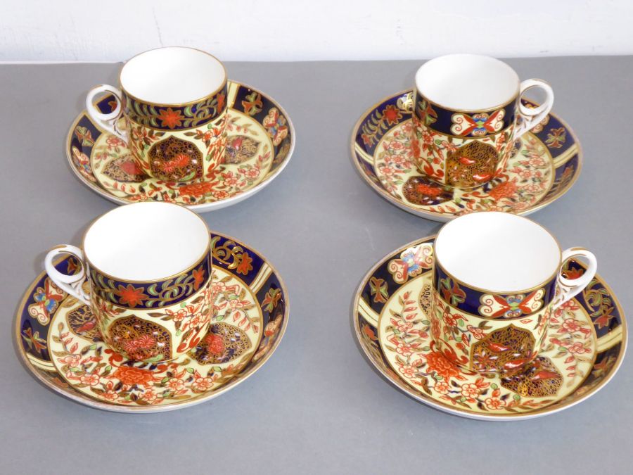 A set of four early 20th century Royal Crown Derby porcelain coffee cans and saucers; each finely