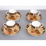 A set of four early 20th century Royal Crown Derby porcelain coffee cans and saucers; each finely