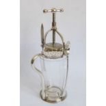 An early 20th century silver-plate-mounted fruit press; complete with knife and spoon