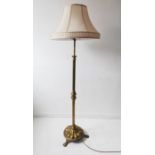 An early 20th century heavy brass lamp standard with silk shade; the adjustable fluted column