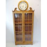 A 19th century pine housekeeper's type cupboard; the central clock with cream-enamel dial with Roman