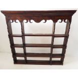 An early 19th century oak dresser superstructure with ornate carved frieze below an outset cornice