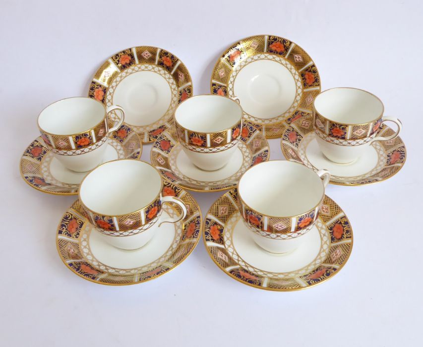 Five Royal Crown Derby coffee cups and (seven) saucers. Each piece finely gilded and decorated in