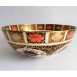 A Royal Crown Derby bowl; hand gilded and decorated in the Imari palette (badly damaged and
