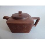 A Chinese Yixing (Zisha) pottery teapot; squat, slightly tapering square form and incised with