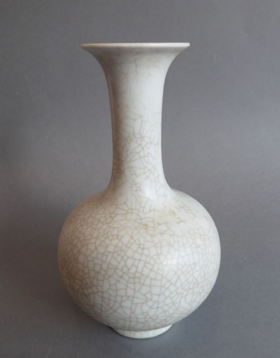 A heavy Chinese porcelain bottle-shaped crackleware vase; inverted rim above a tall slender neck and