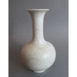 A heavy Chinese porcelain bottle-shaped crackleware vase; inverted rim above a tall slender neck and