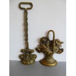 Two heavy brass doorstops, one modelled as a woven basket of flowers (38.5cm and 33cm) (2)