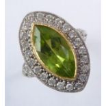 An 18-carat gold, peridot and diamond cluster ring; ring size N