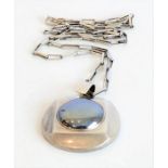 A highly unusual hallmarked silver circular pendant and chain, the pendant with central polished
