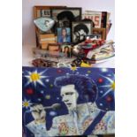 A large variety of Elvis Presley memorabilia to include a 1950s-style alarm clock, various printed