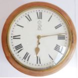 An early 20th century circular mahogany cased stationmaster's style wall-hanging clock, white-enamel