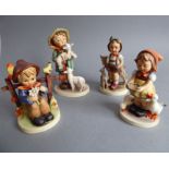 Four hand-decorated West German Goebel figures; in typical style and modelled as children with
