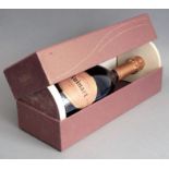 A cased bottle of Ruinart Brut Rosé champagne