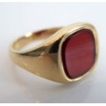 A gentleman's 9-carat yellow-gold signet ring set with a central stone possibly carnelian, ring size