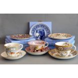 Eight Wedgwood collector's plates (boxed) and three oversized cups and saucers. The latter