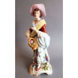 A large early 20th century Sitzendorf figurine of a female flower seller; hand-painted and marked to