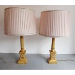 A pair of Classical-style wooden table lamps; lacquered and hand-gilded with wreaths and flowers (