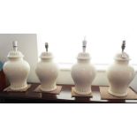 A set of four baluster-shaped cream ceramic table lamps (34cm high not including electrical