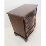 A serpentine-fronted four-drawer chest with brushing slide; mid-20th century in late 18th century