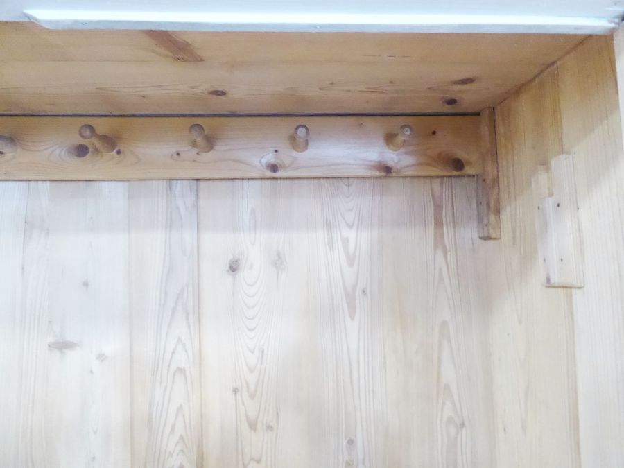 A Continental-style two-door pine wardrobe; white-painted, raised on turned feet, probably early - Image 4 of 4