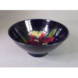 A small Moorcroft Pottery bowl; tube-lined and hand-decorated with an interior flower in the Pansy