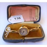 A lady's 18-carat yellow gold wristwatch; the dial with black Arabic numerals and steeled hands,