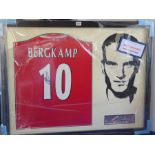 An original framed and glazed football shirt signed by Dennis Bergkamp of Arsenal, together with