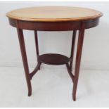 An Edwardian oval mahogany occasional table; the banded top above four square slightly tapering