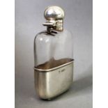 A silver-mounted spirit flask by G. & J. W. Hawksley; the bun-shaped silver top swivelling open