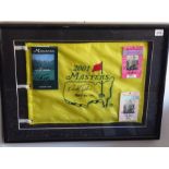 An ebonised framed and glazed golfing montage '2001 Masters'; the yellow flag signed by Nick Faldo