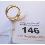 An 18-carat yellow gold wedding band, engraved decoration, worn, size J-K (7.3g)