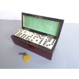 A 19th century rosewood brass-strung box (possibly French and with key) containing 28 bone and ebony