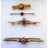 Four late Victorian/Edwardian 9-carat yellow gold bar brooches: one set with a rose-cut diamond